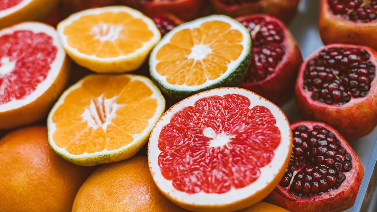 Vibrant close-up of sliced citrus fruits and pomegranates showcasing freshness and variety.
